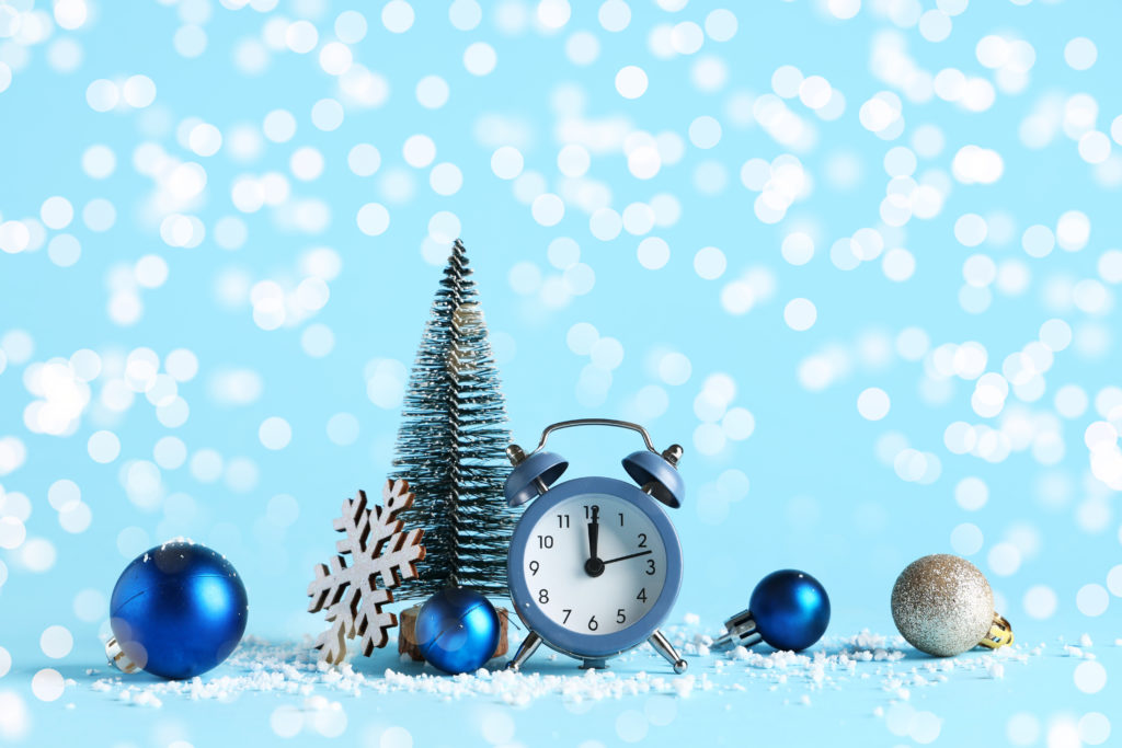 Holiday hours SEO concept showing clock and winter decorations, representing seasonal Google Business Profile updates in December.
